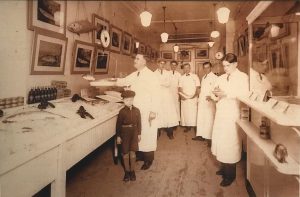 Six men and one boy standing inside the Upper East Side butcher shop